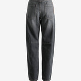 Black pants worn by a person, showing the pants' fit