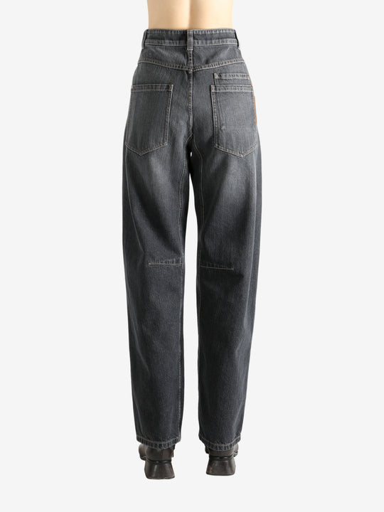 Black pants worn by a person, showing the pants' fit