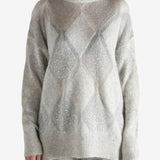 Grey knitwear worn by a person, showing the knitwear's fit