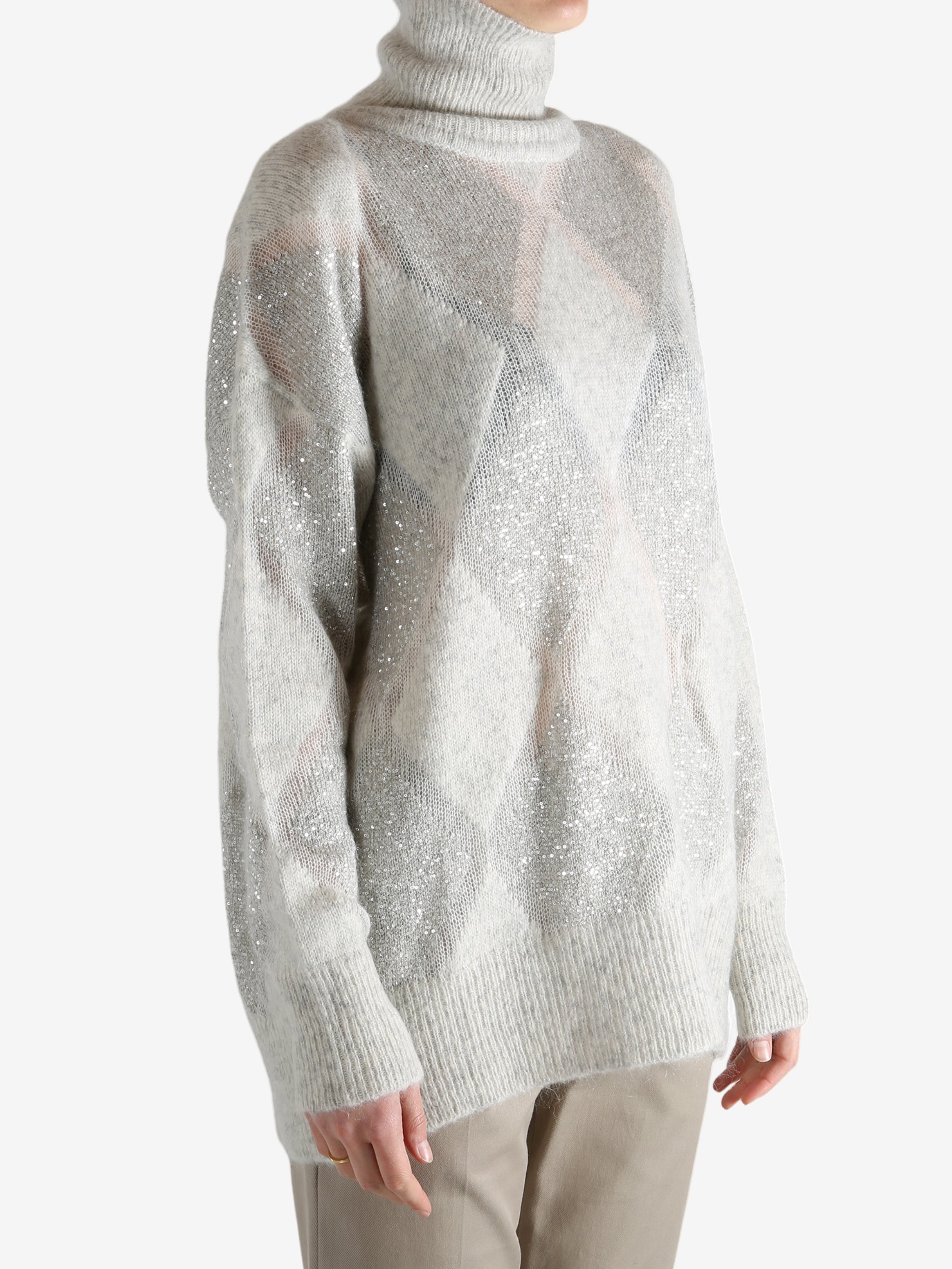 Grey knitwear worn by a person, showing the knitwear's fit