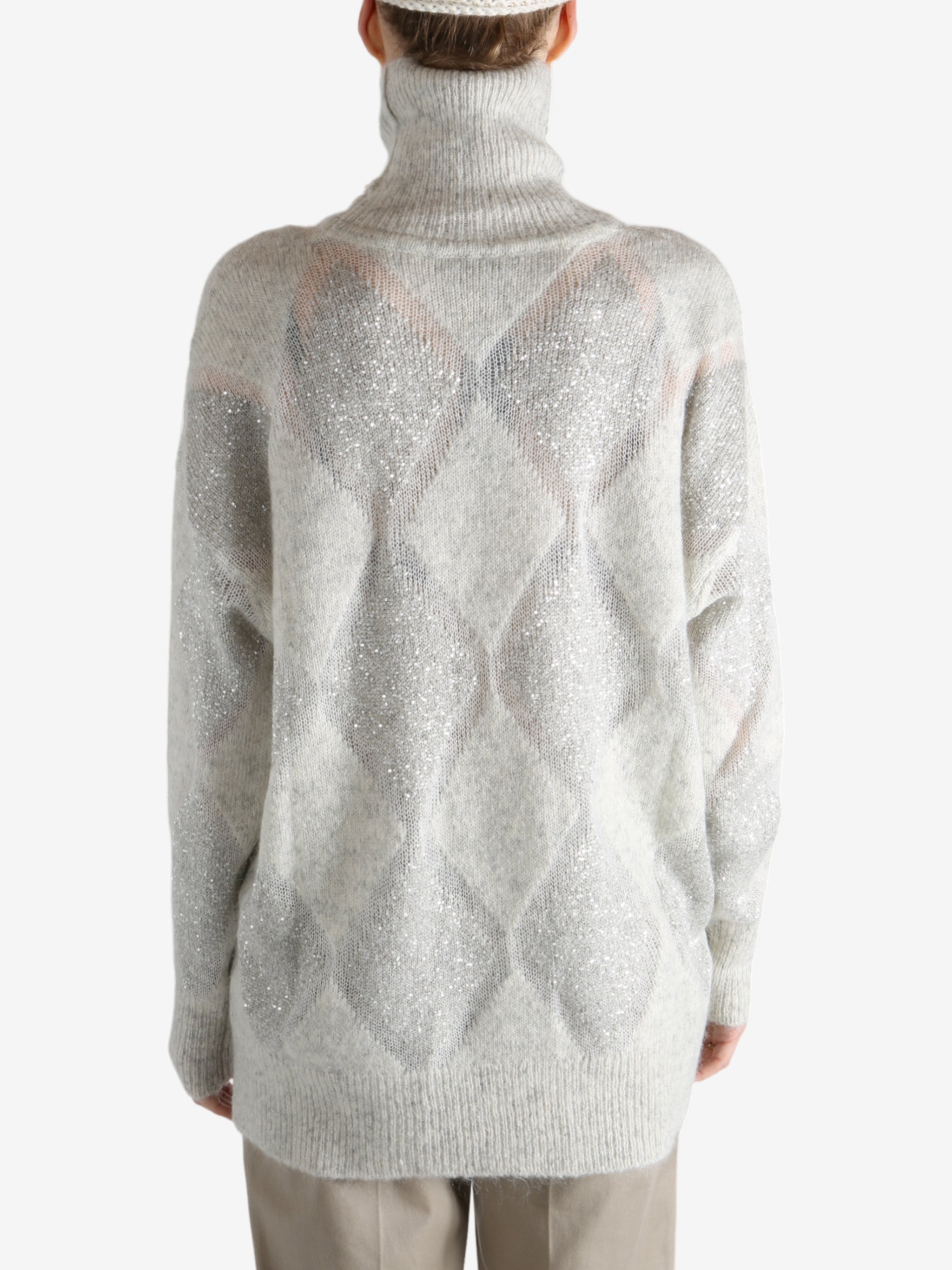 Grey knitwear worn by a person, showing the knitwear's fit