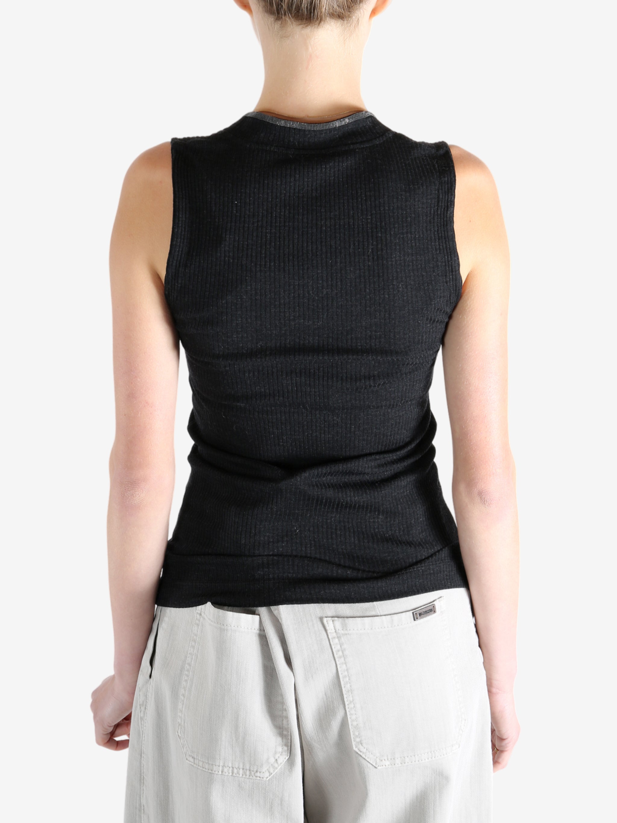 Black top worn by a person, showing the top's fit