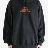 Black hoodie worn by a person, showing the hoodie's fit