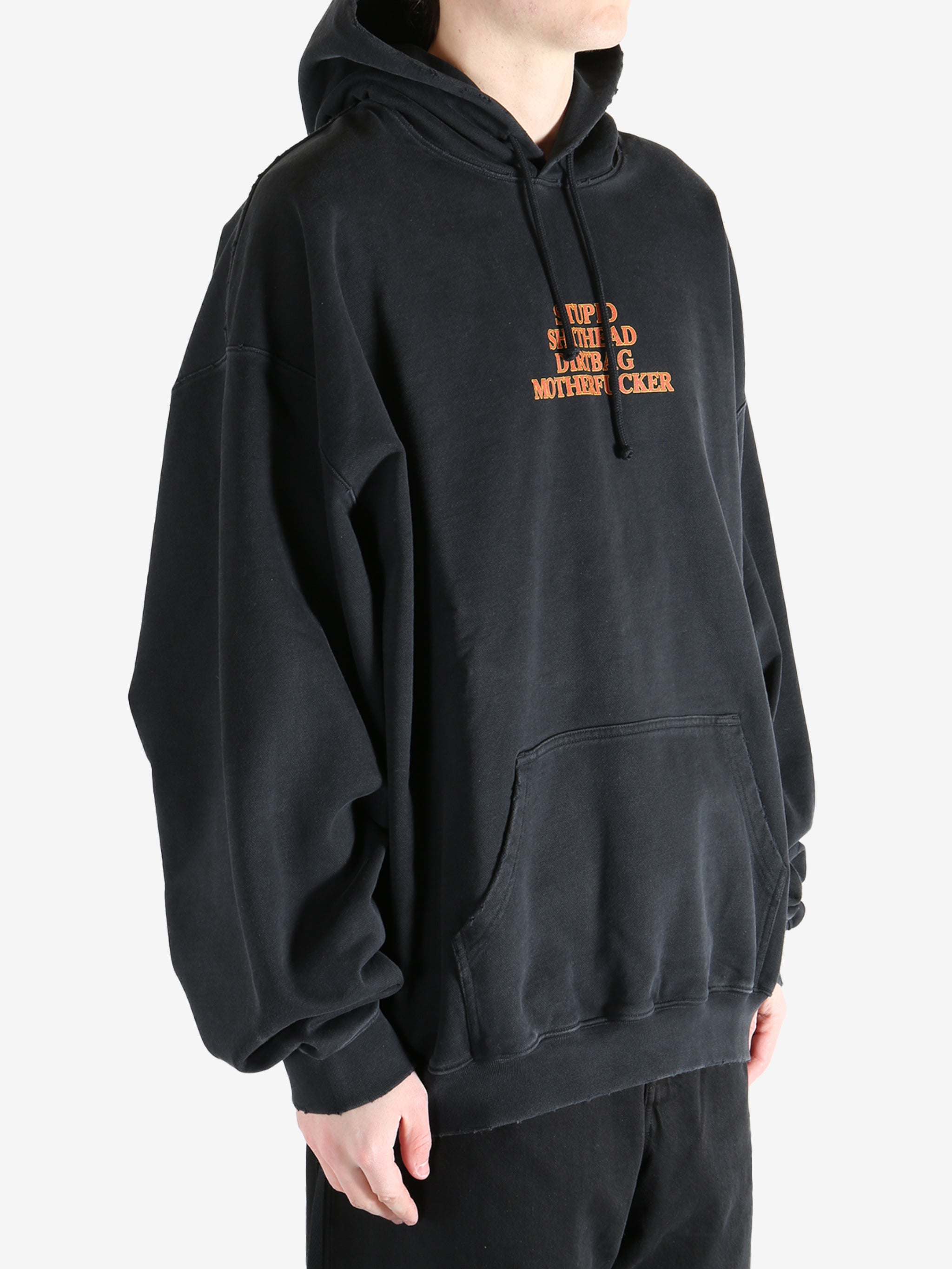 Black hoodie worn by a person, showing the hoodie's fit