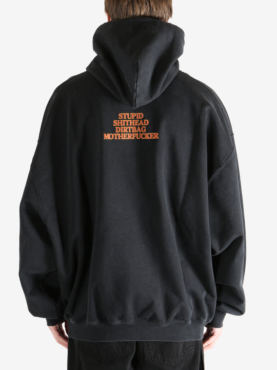 Black hoodie worn by a person, showing the hoodie's fit