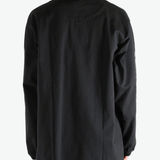 Black shirt worn by a person, showing the  shirt fit