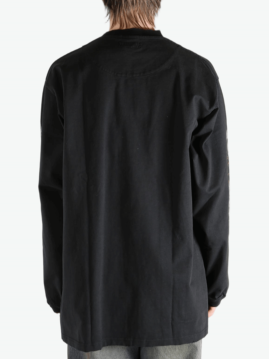 Black shirt worn by a person, showing the  shirt fit
