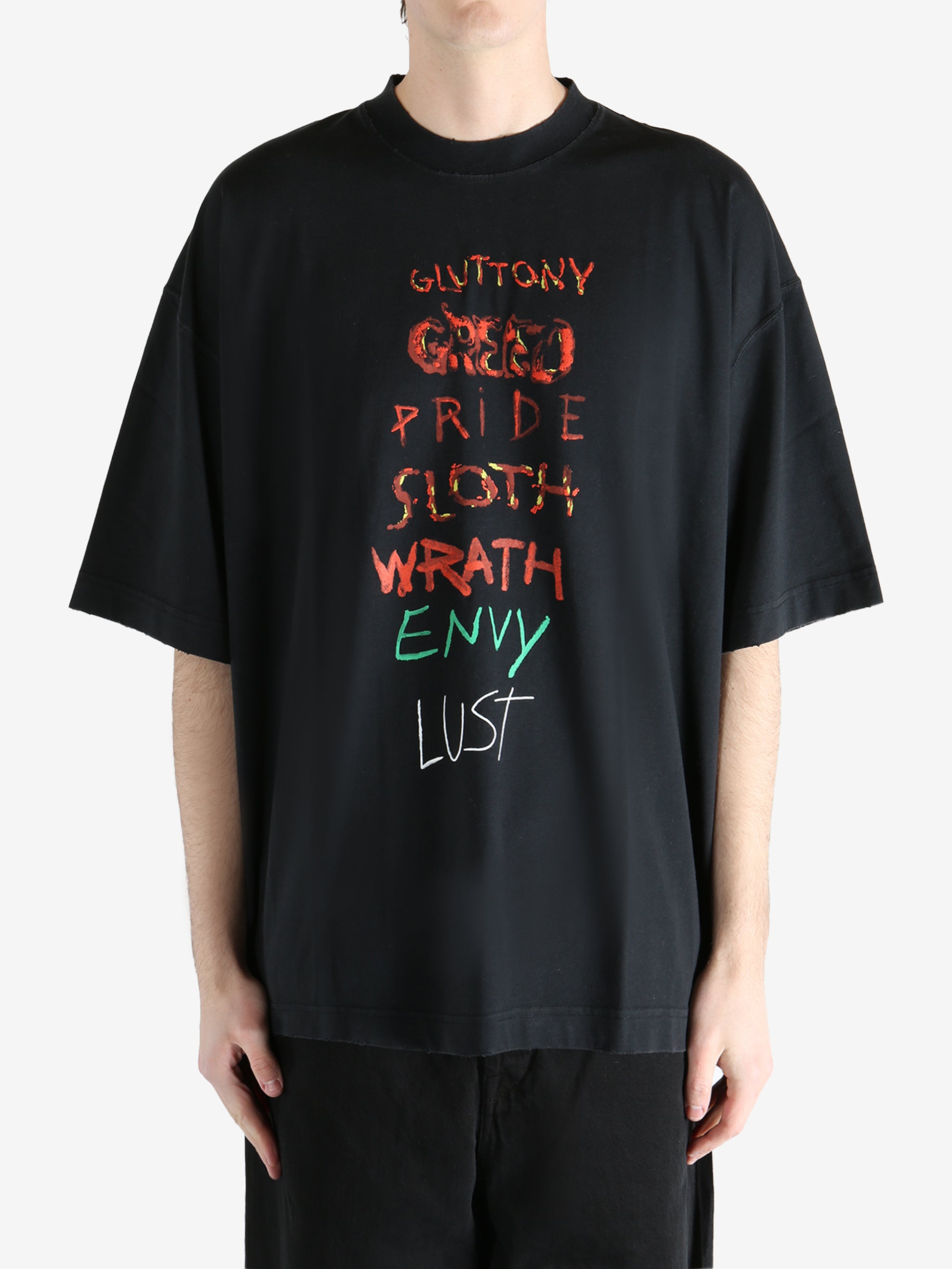 Black T-shirt worn by a person, showing the shirt fit