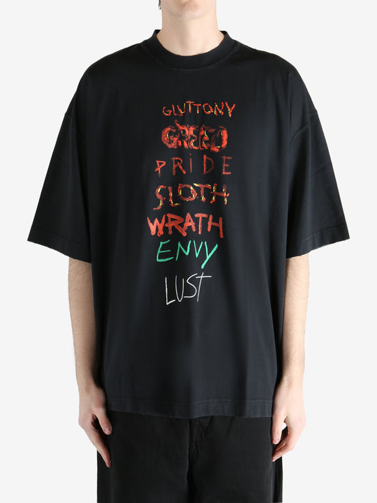 Black T-shirt worn by a person, showing the shirt fit