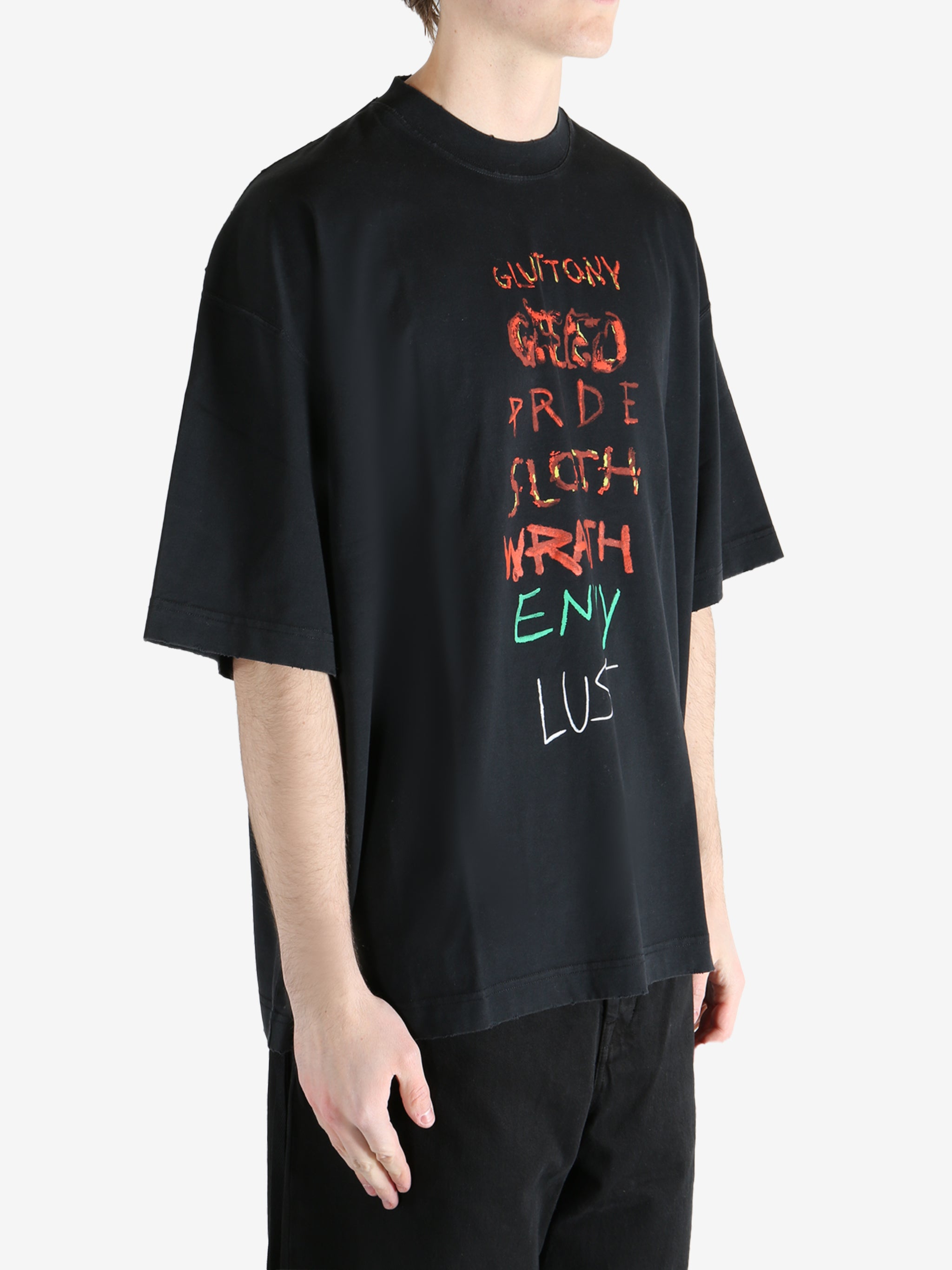 Black T-shirt worn by a person, showing the shirt fit