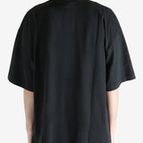 Black T-shirt worn by a person, showing the shirt fit