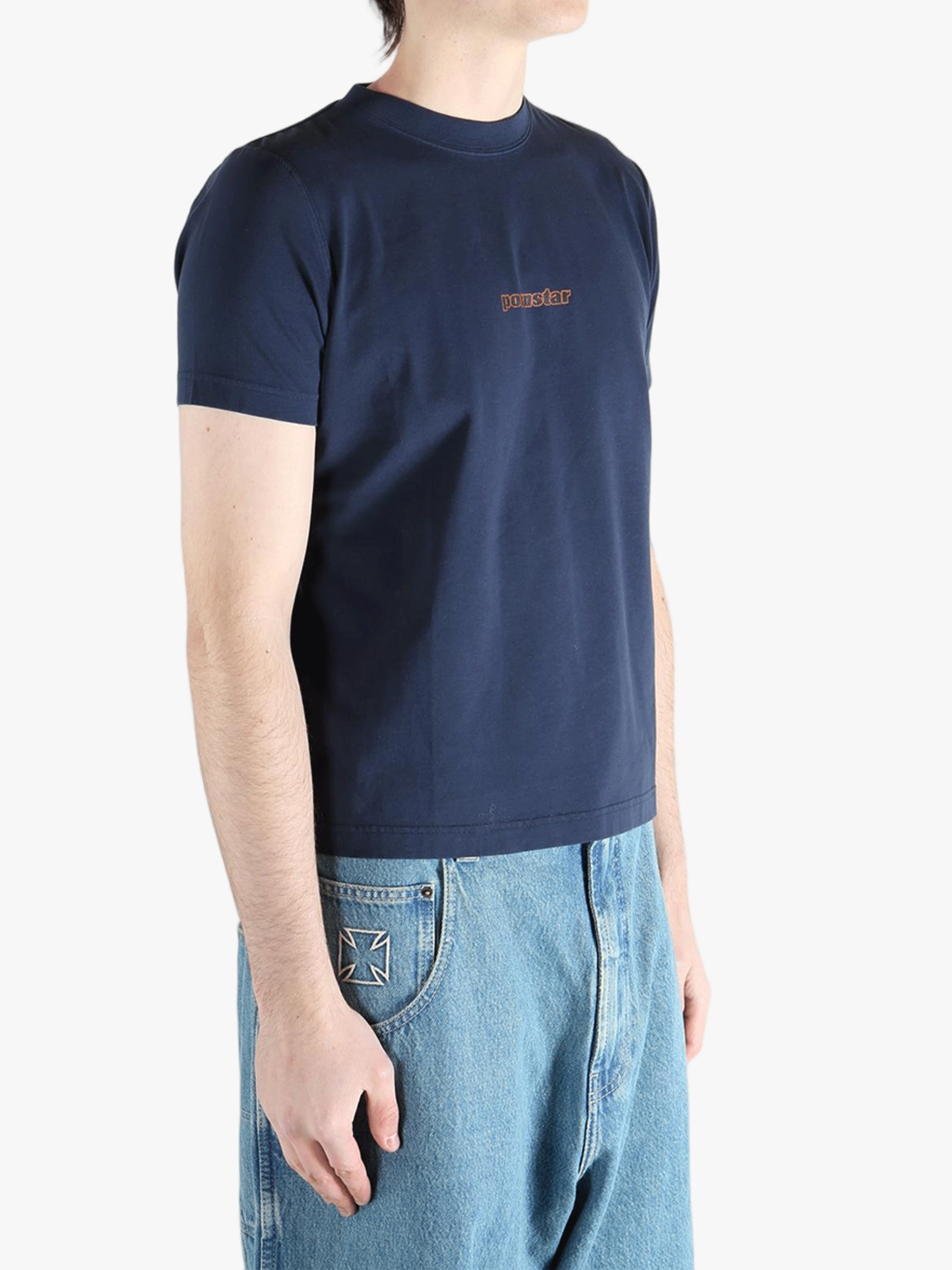 Navy t-shirt worn by a person, showing the shirt's fit