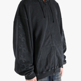 Black hoodie worn by a person, showing the hoodie fit