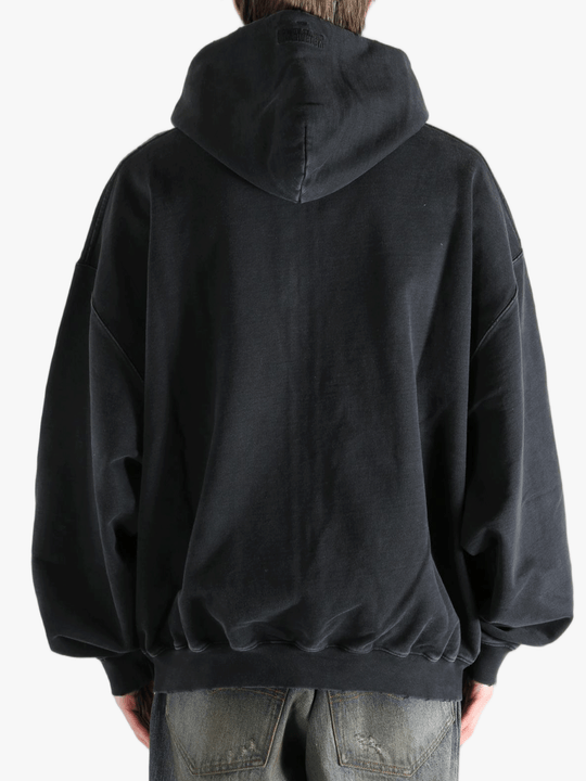 Black hoodie worn by a person, showing the hoodie fit