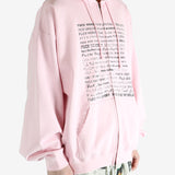 Pink hoodie worn by a person, showing the hoodie fit