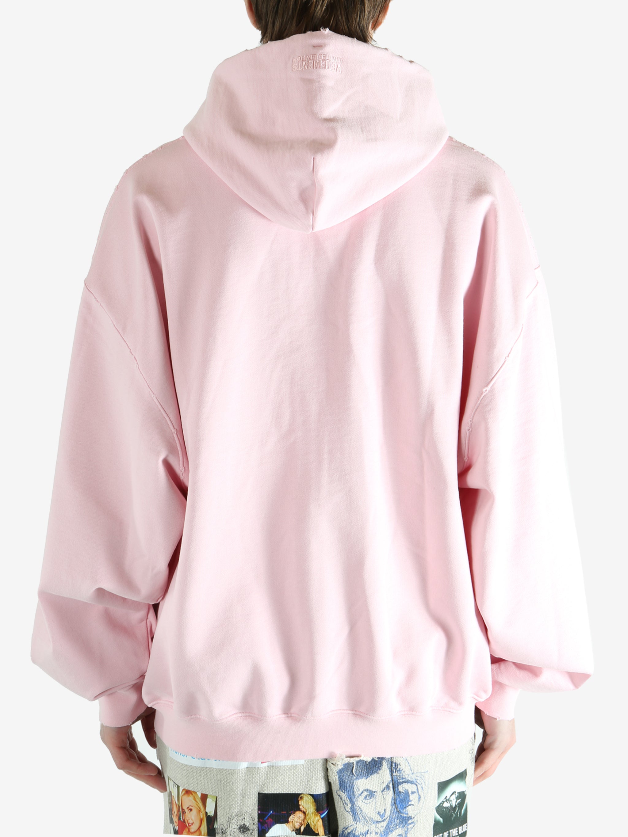 Pink hoodie worn by a person, showing the hoodie fit