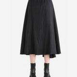 Black skirt worn by a person, back view