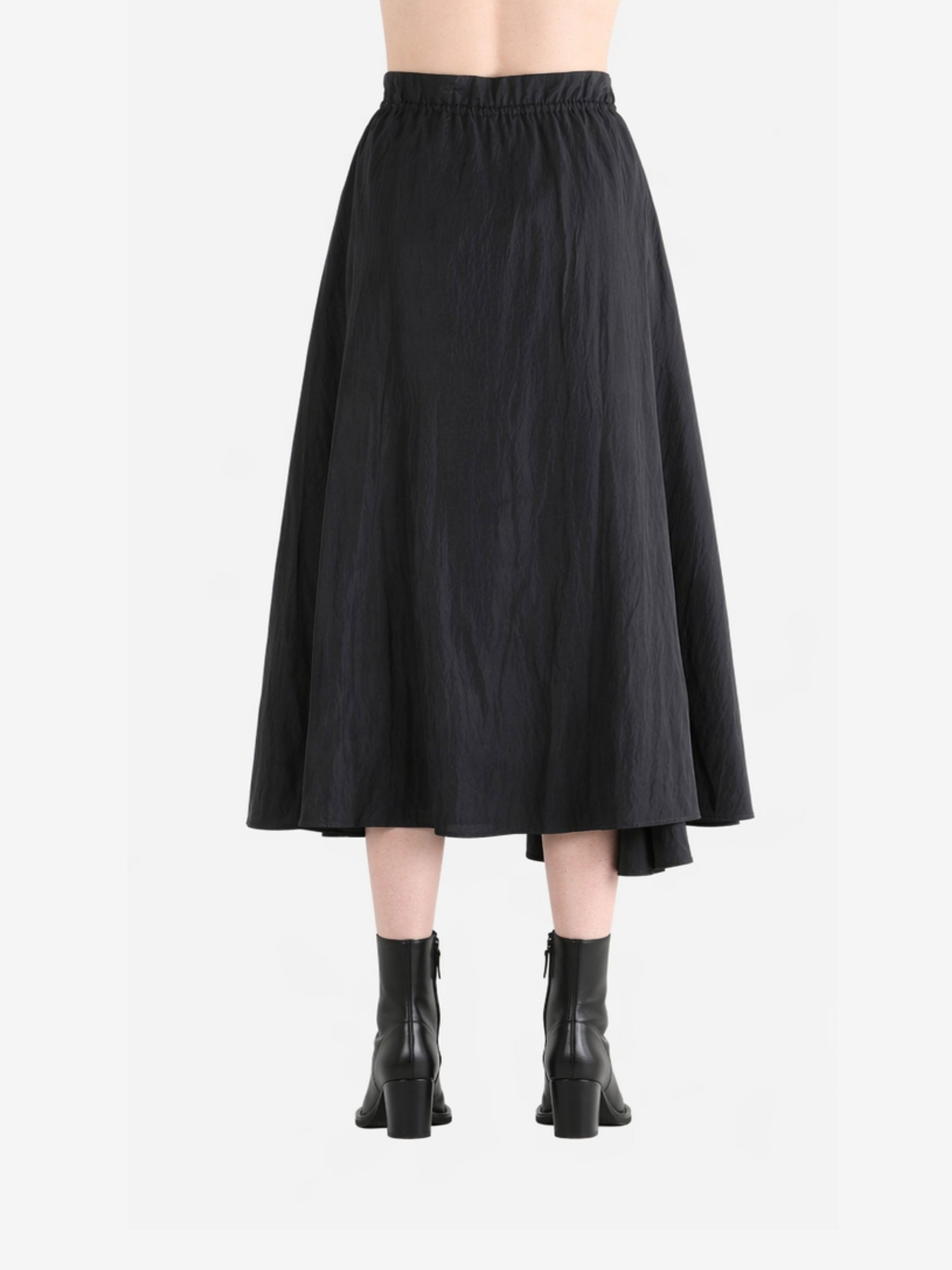 Black skirt worn by a person, back view