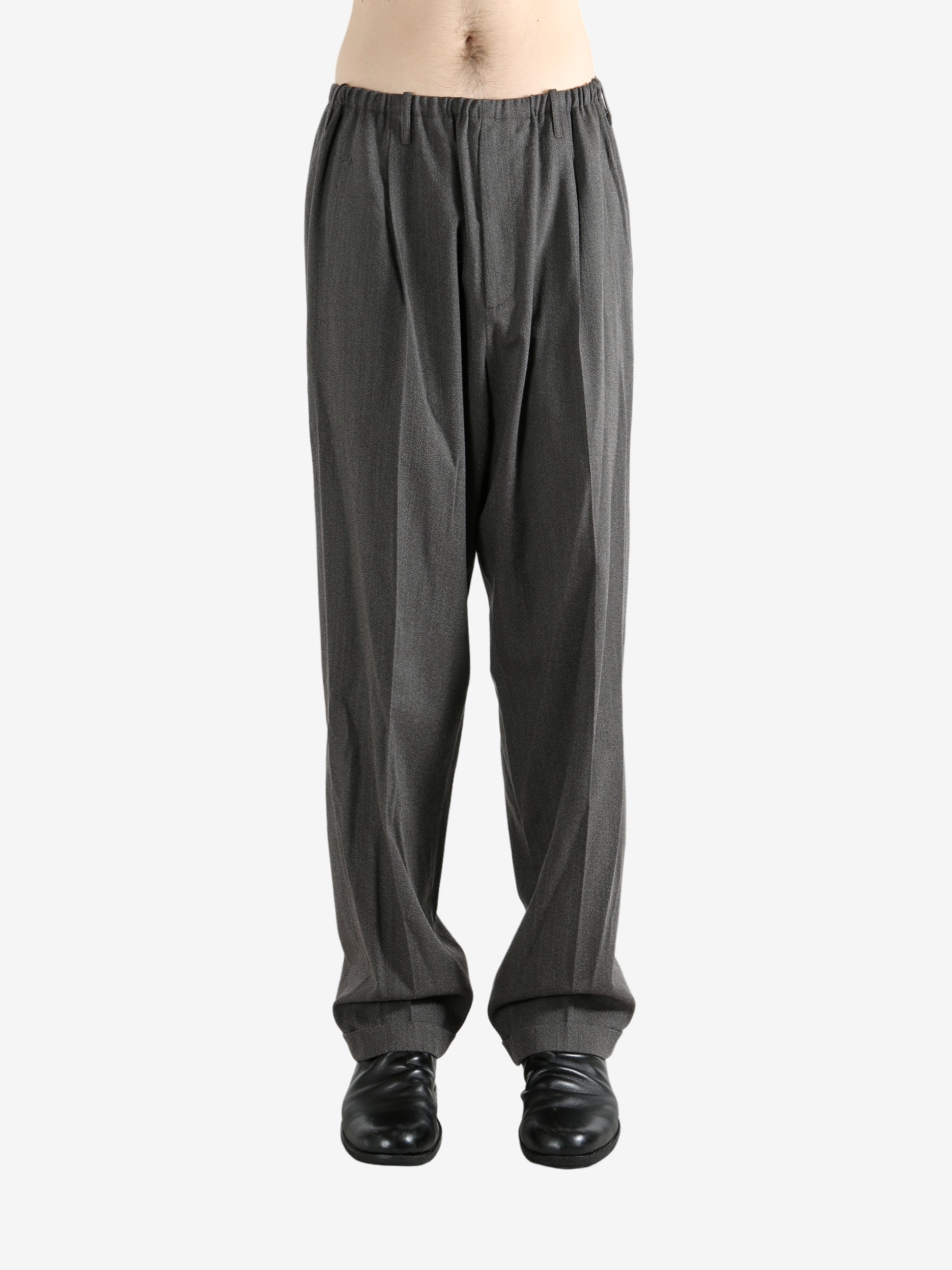 Grey pants worn by a person, showing the pants fit