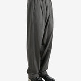 Grey pants worn by a person, showing the pants fit