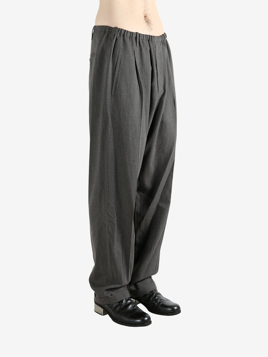 Grey pants worn by a person, showing the pants fit