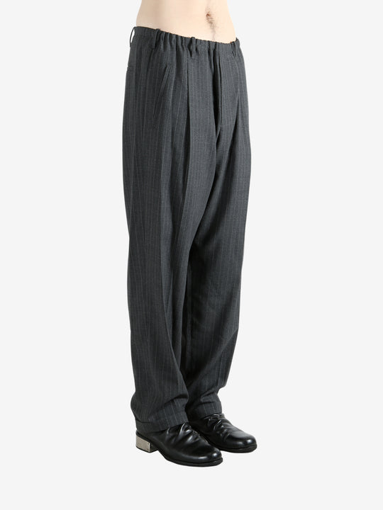 Grey pants worn by a person, showing the pants fit