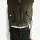 Green jacket worn by a person, showing the jacket's fit