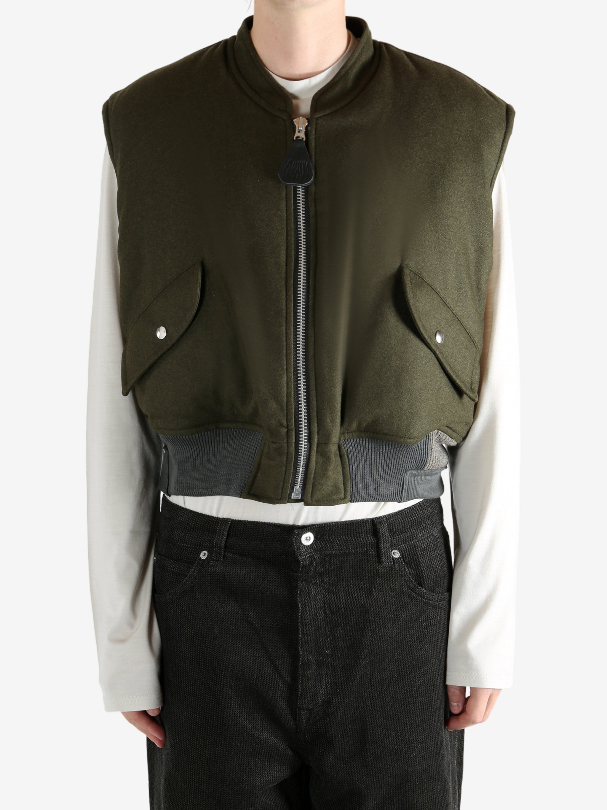 Green jacket worn by a person, showing the jacket's fit