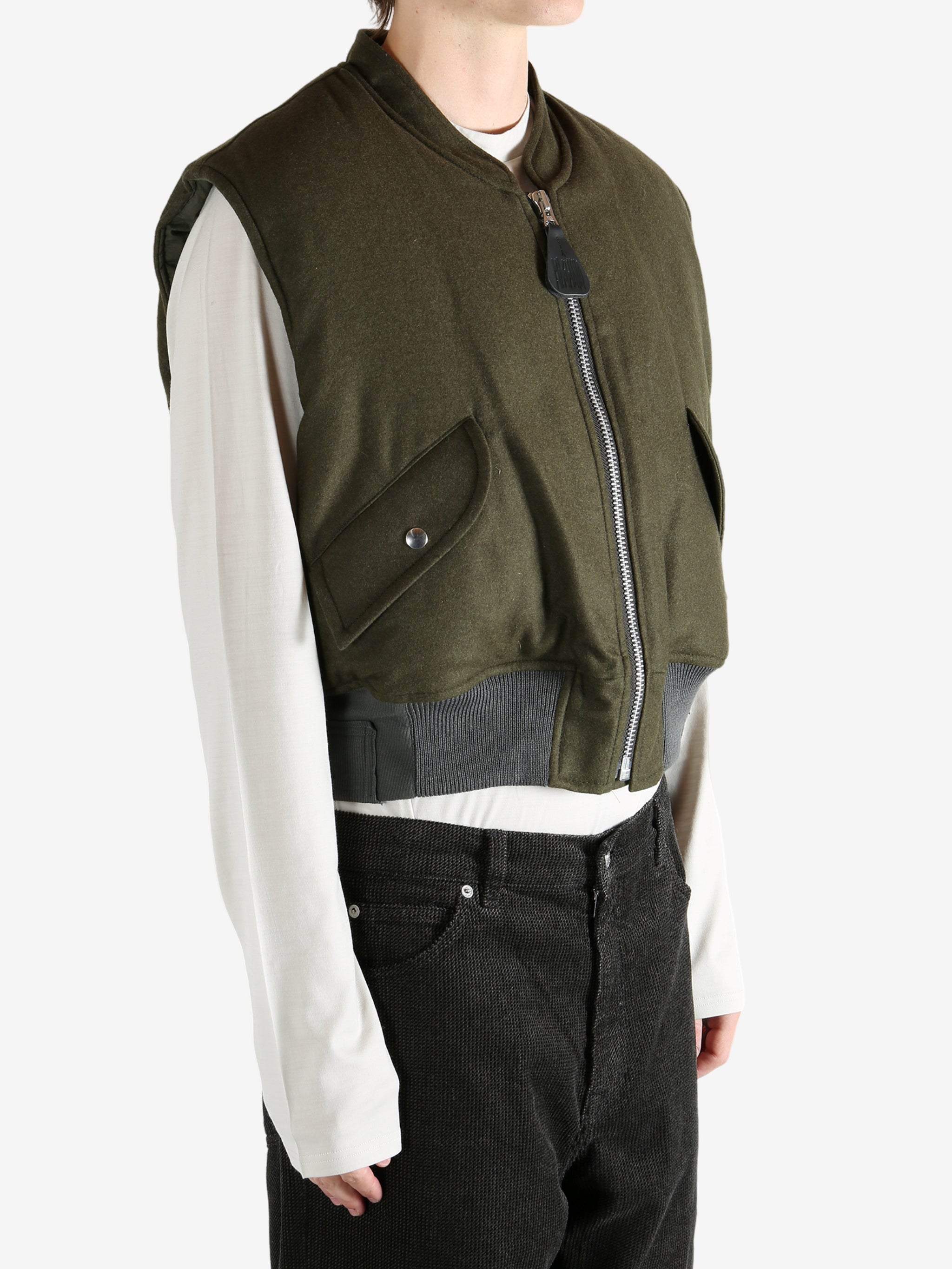 Green jacket worn by a person, showing the jacket's fit