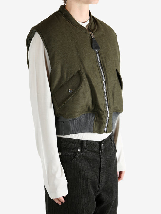 Green jacket worn by a person, showing the jacket's fit