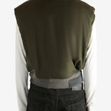 Green jacket worn by a person, showing the jacket's fit