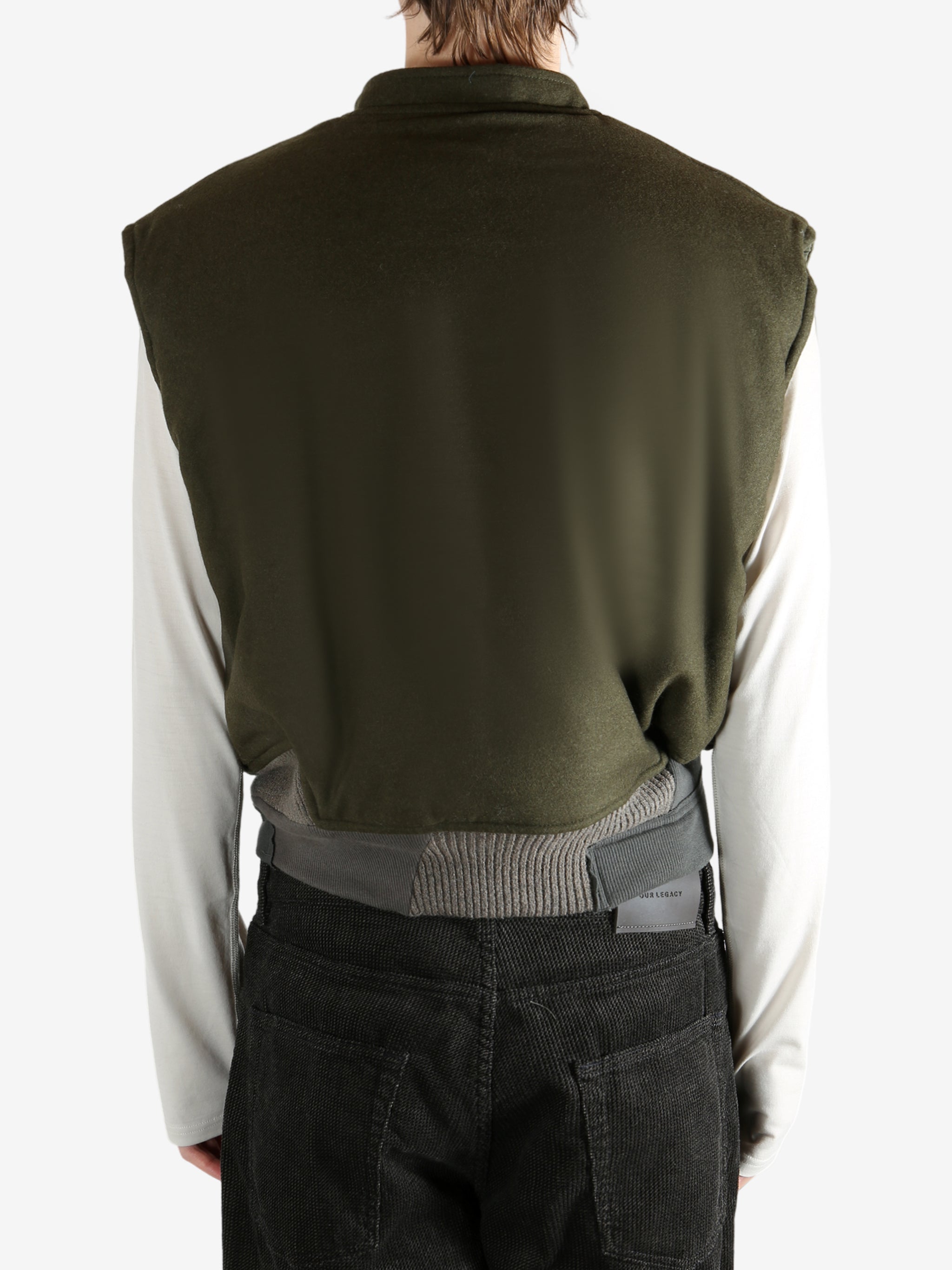 Green jacket worn by a person, showing the jacket's fit