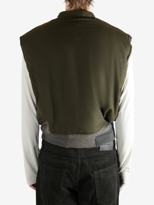 Green jacket worn by a person, showing the jacket's fit