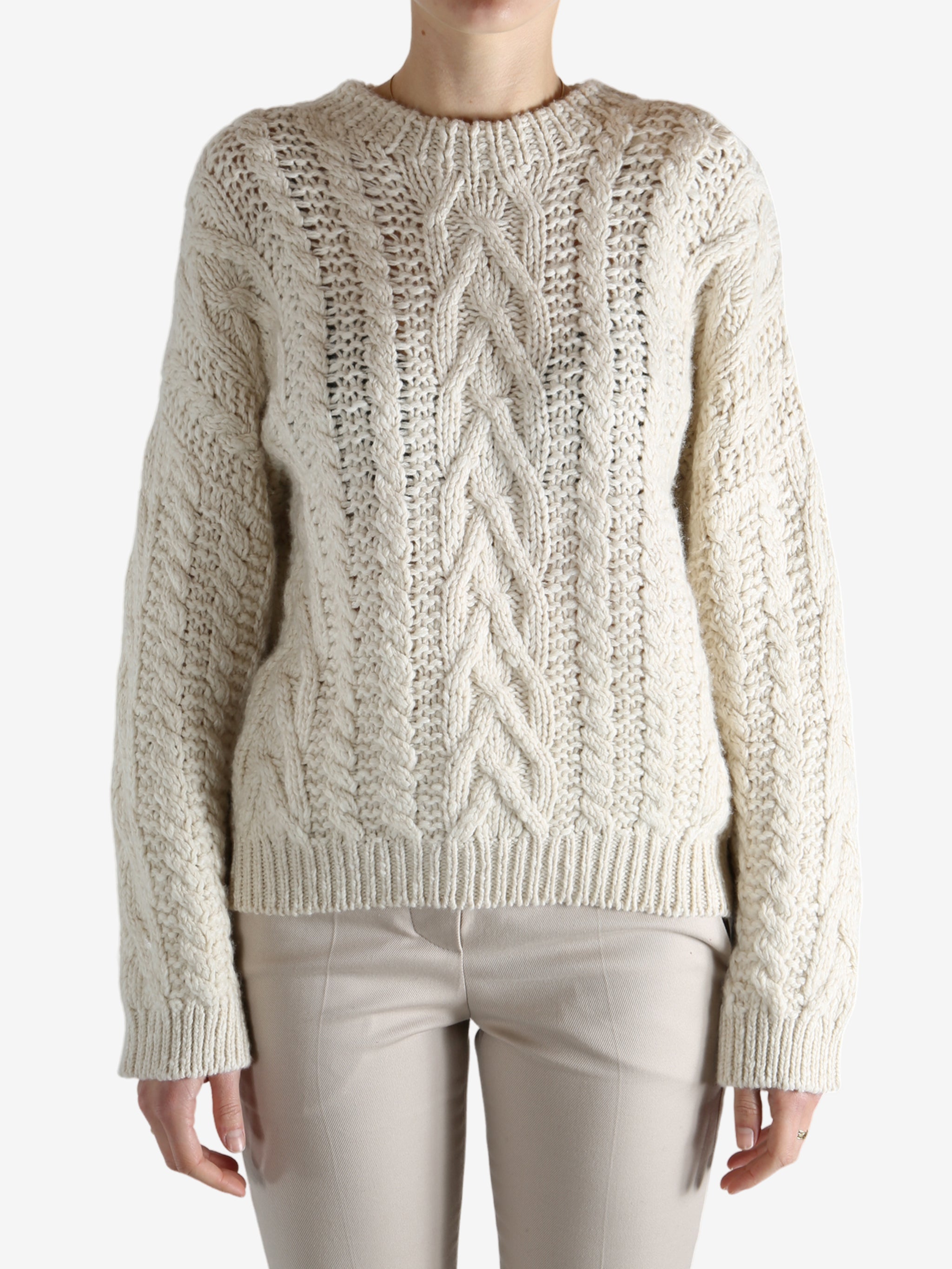 White knitwear worn by a person, showing theknitwear's fit