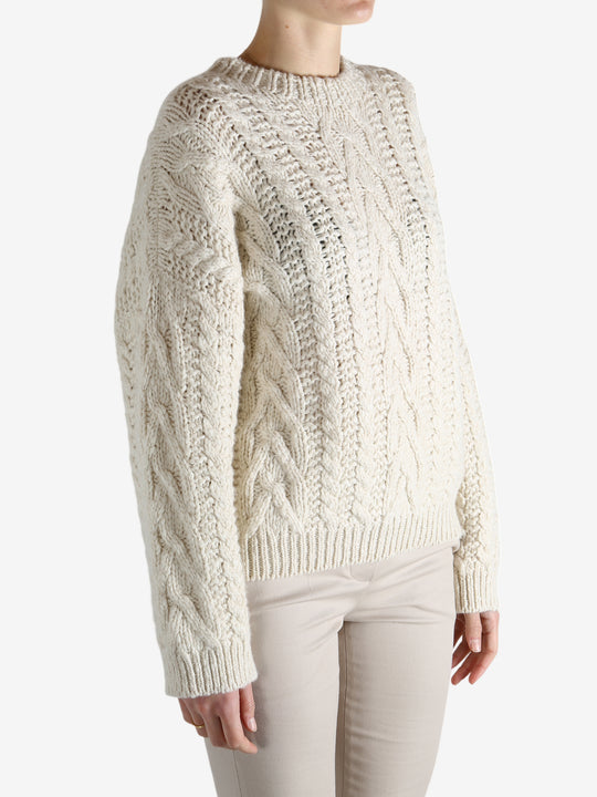 White knitwear worn by a person, showing theknitwear's fit