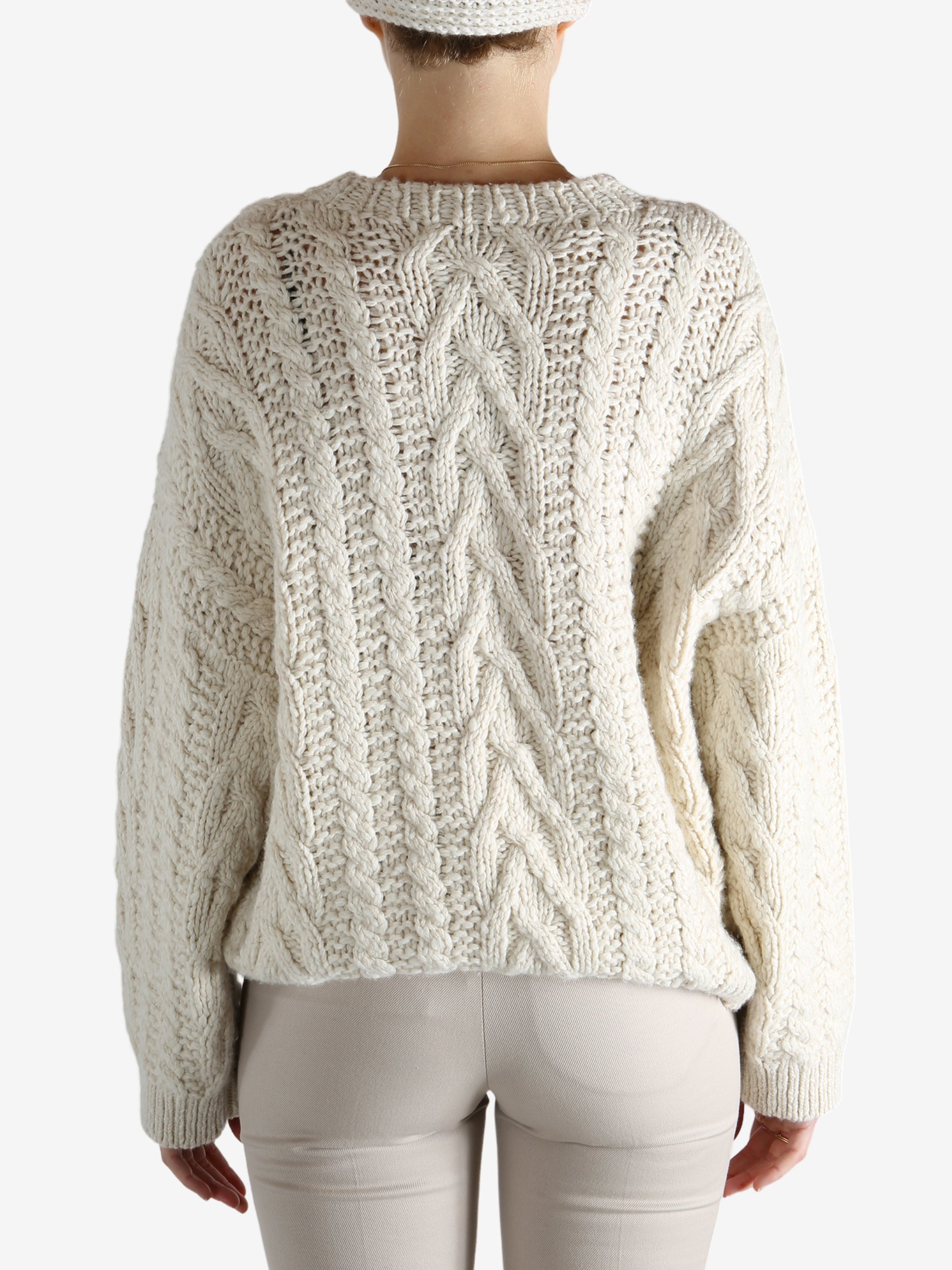 White knitwear worn by a person, showing theknitwear's fit