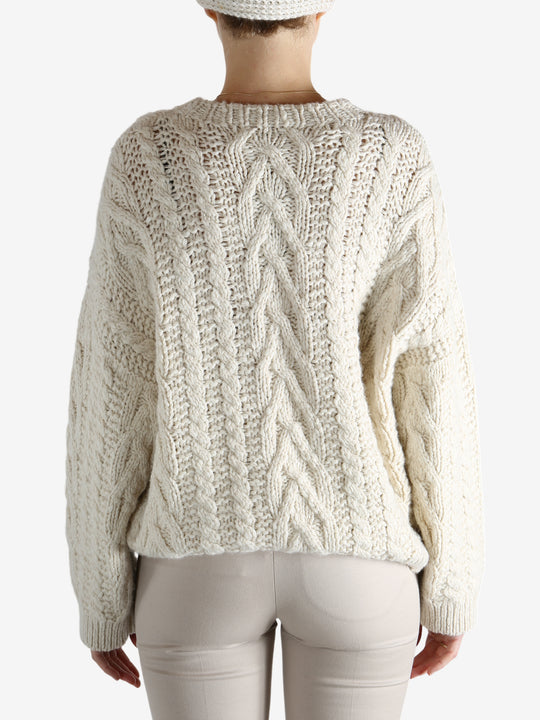 White knitwear worn by a person, showing theknitwear's fit