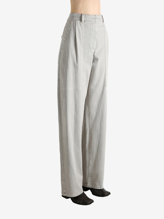 Grey pants worn by a person, showing the pants' fit