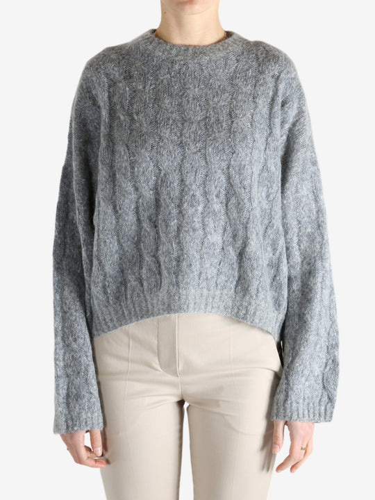 Grey sweater worn by a person, showing the sweater's fit