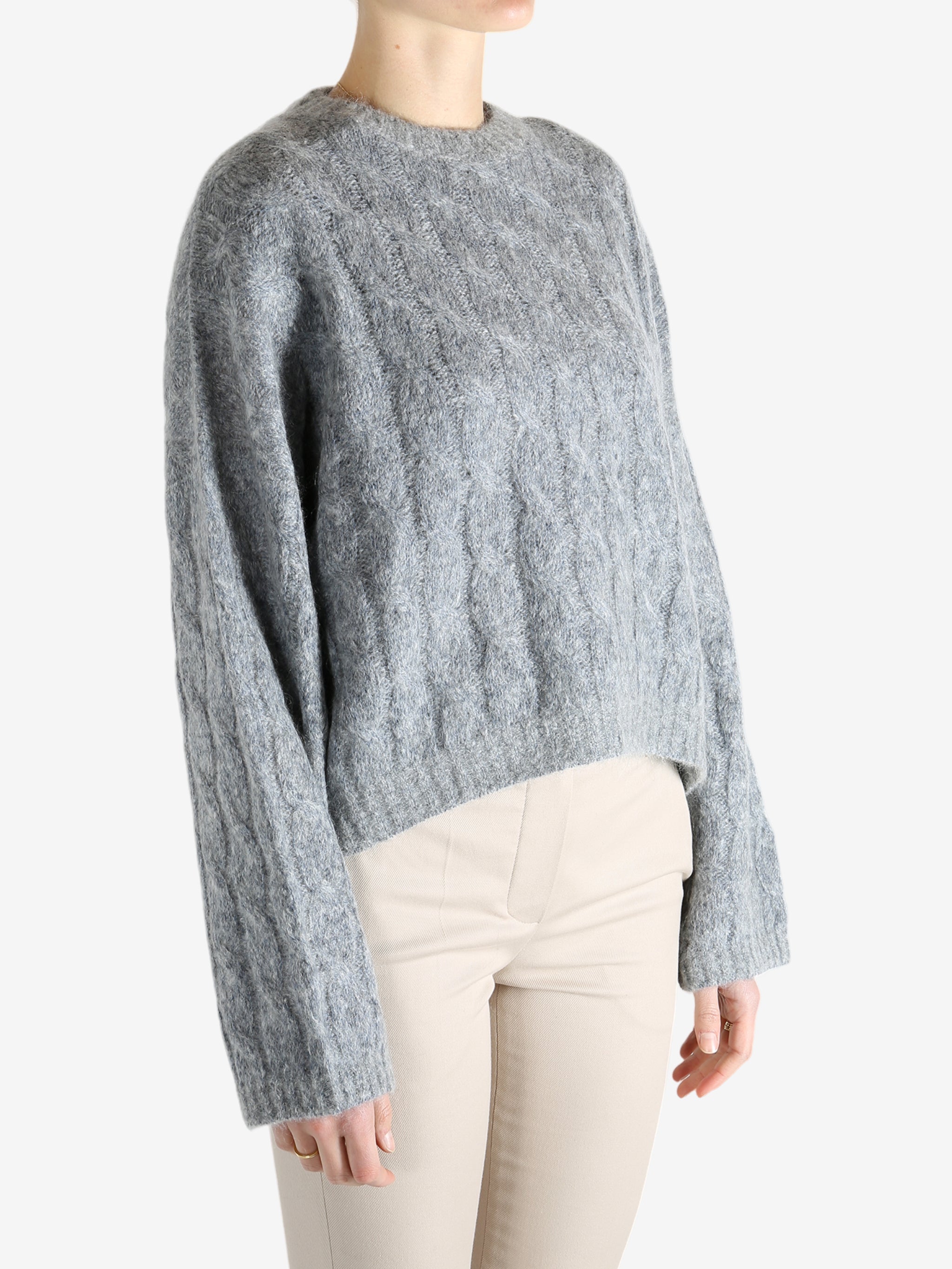 Grey sweater worn by a person, showing the sweater's fit