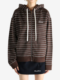 Brown hoodie worn by a person, showing the hoodie's fit