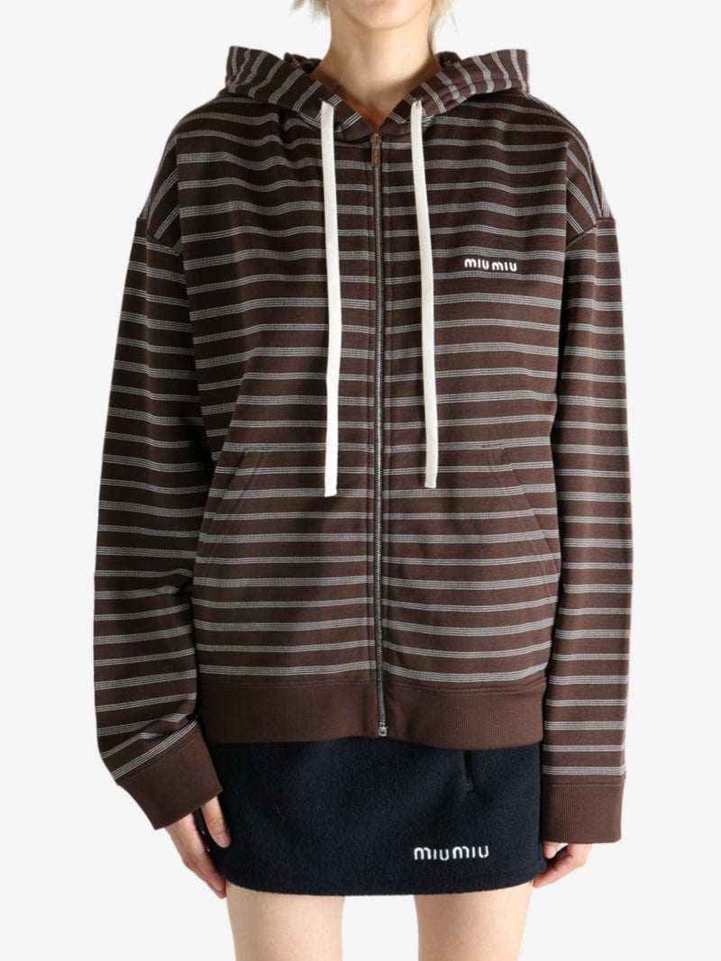 Brown hoodie worn by a person, showing the hoodie's fit