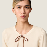 Tan t-shirt worn by a person, showing the t-shirt fit