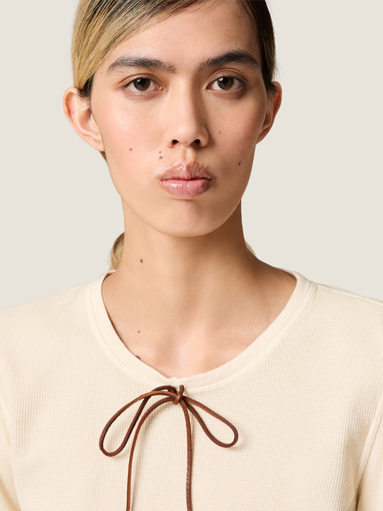 Tan t-shirt worn by a person, showing the t-shirt fit