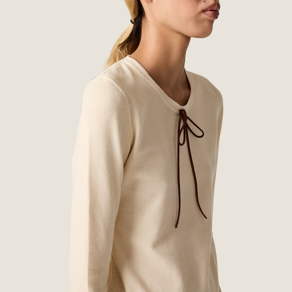 Tan t-shirt worn by a person, showing the t-shirt fit