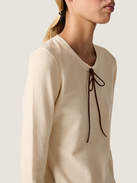 Tan t-shirt worn by a person, showing the t-shirt fit
