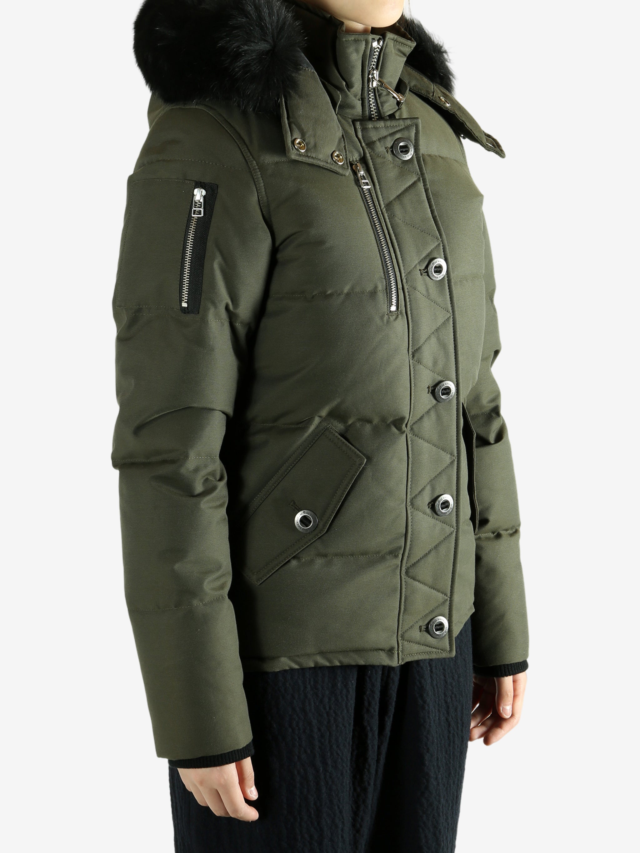 Green jackets worn by a person, showing the jackets fit