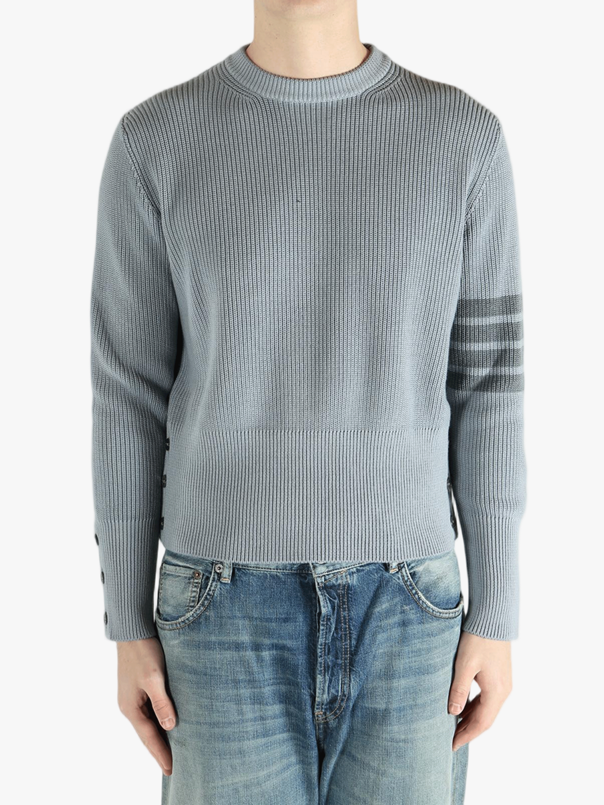 Grey pullover worn by a person, showing the pullover fit