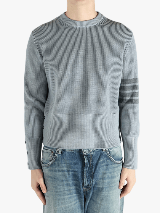Grey pullover worn by a person, showing the pullover fit