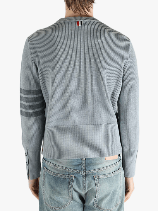 Grey pullover worn by a person, showing the pullover fit